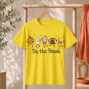 Cute Halloween Pumpkin Ghost Football Coffee Candy Corn Shirt displayed on a yellow t-shirt, celebrating the spooky season.