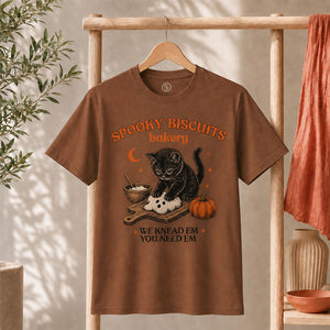Kitty Biscuits Shirt Spooky Season T-shirt featuring a black cat with pumpkin design on a brown tee.