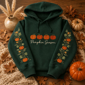 Pumpkin Season Embroidered Hoodie featuring pumpkins and floral designs on a cozy green hoodie for fall.