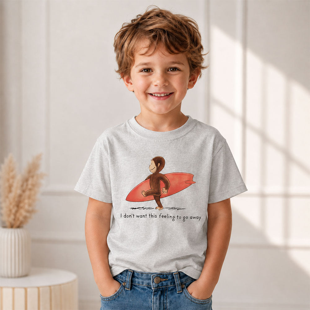 Curious Surfer Monkey Shirt Nostalgic Summer Beach Graphic Tee on a smiling child wearing a surfboard design.