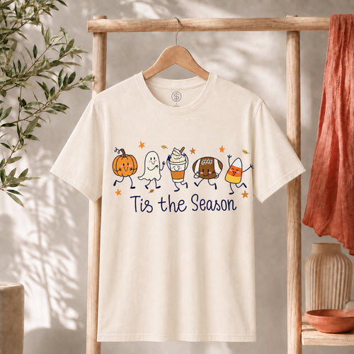 Cute Halloween Pumpkin Ghost Football Coffee Candy Corn Shirt displayed on hanger, featuring colorful cartoon designs.