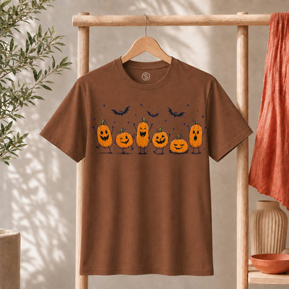 Cute Halloween Pumpkin Shirt displayed on a hanger with expressive orange pumpkins and bats in a cozy setting.