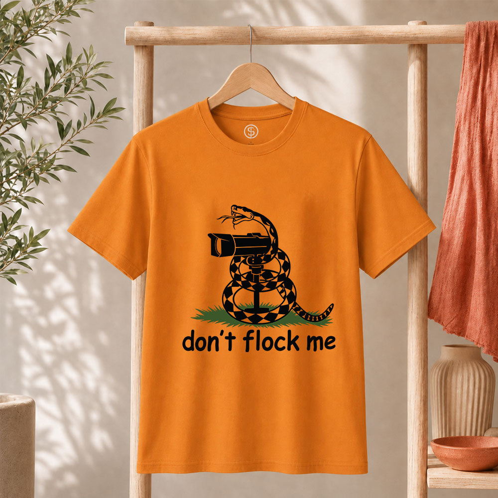 Dont Flock Me Snake With Camera T Shirt Surveillance Tee on an orange shirt with a humorous snake design.