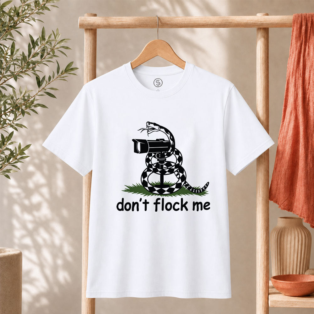 Dont Flock Me Snake With Camera T Shirt displayed on a hanger with a humorous snake design.
