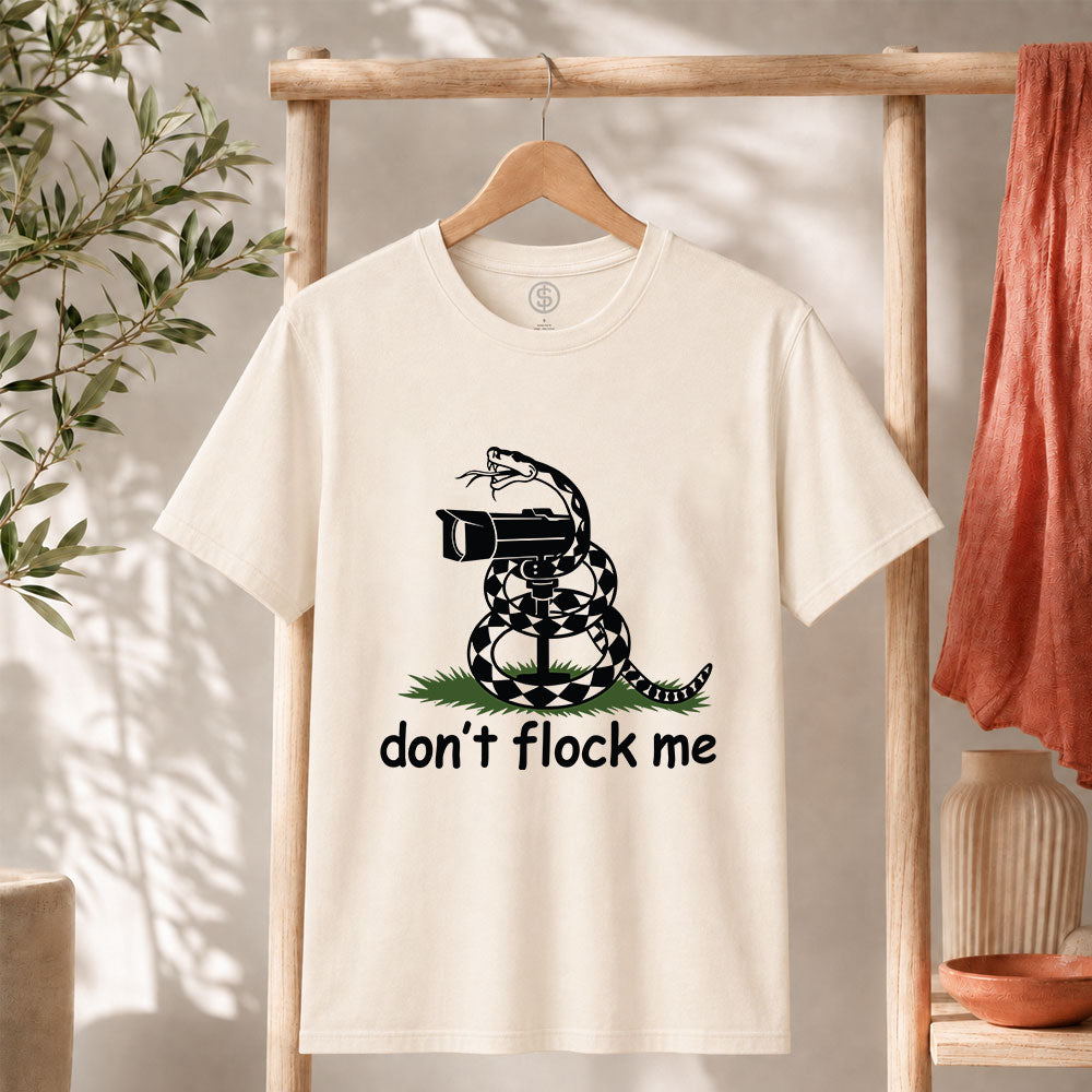 Dont Flock Me Snake With Camera T Shirt displayed on a hanger, featuring a humorous snake design.