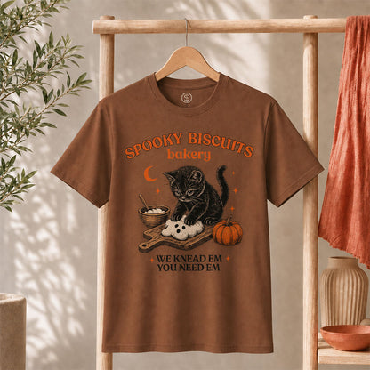 Kitty Biscuits Shirt Spooky Season T-shirt featuring a black cat with pumpkin design on a brown tee.