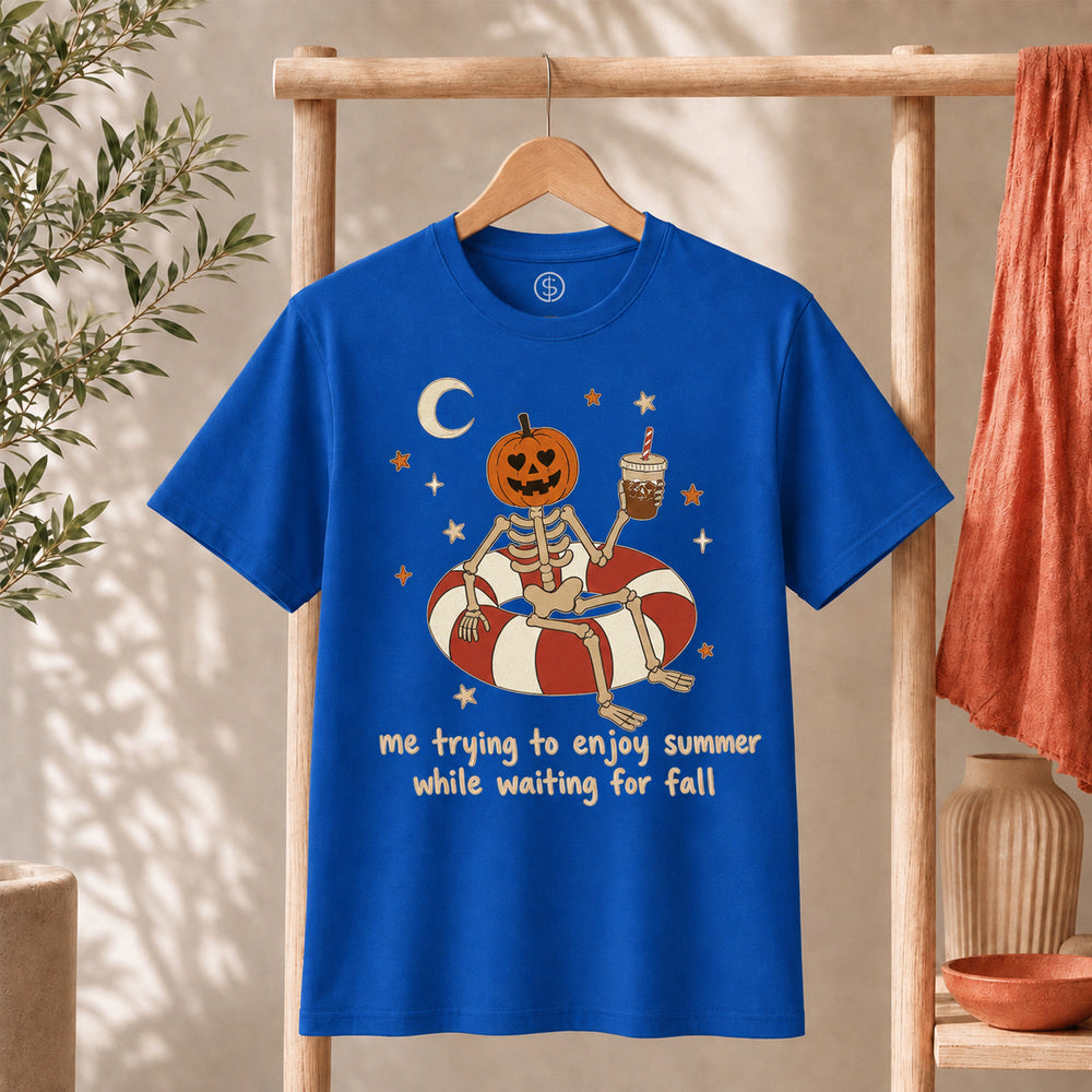 Me Trying to Enjoy Summer While Waiting for Fall Tee featuring a skeleton with a jack-o'-lantern on a float.