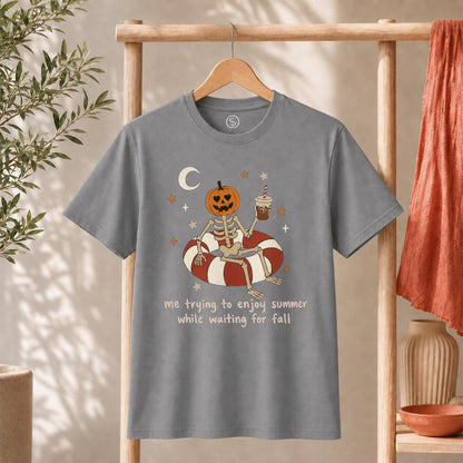 Me Trying to Enjoy Summer While Waiting for Fall Tee on grey shirt with skeleton and jack-o'-lantern graphic.