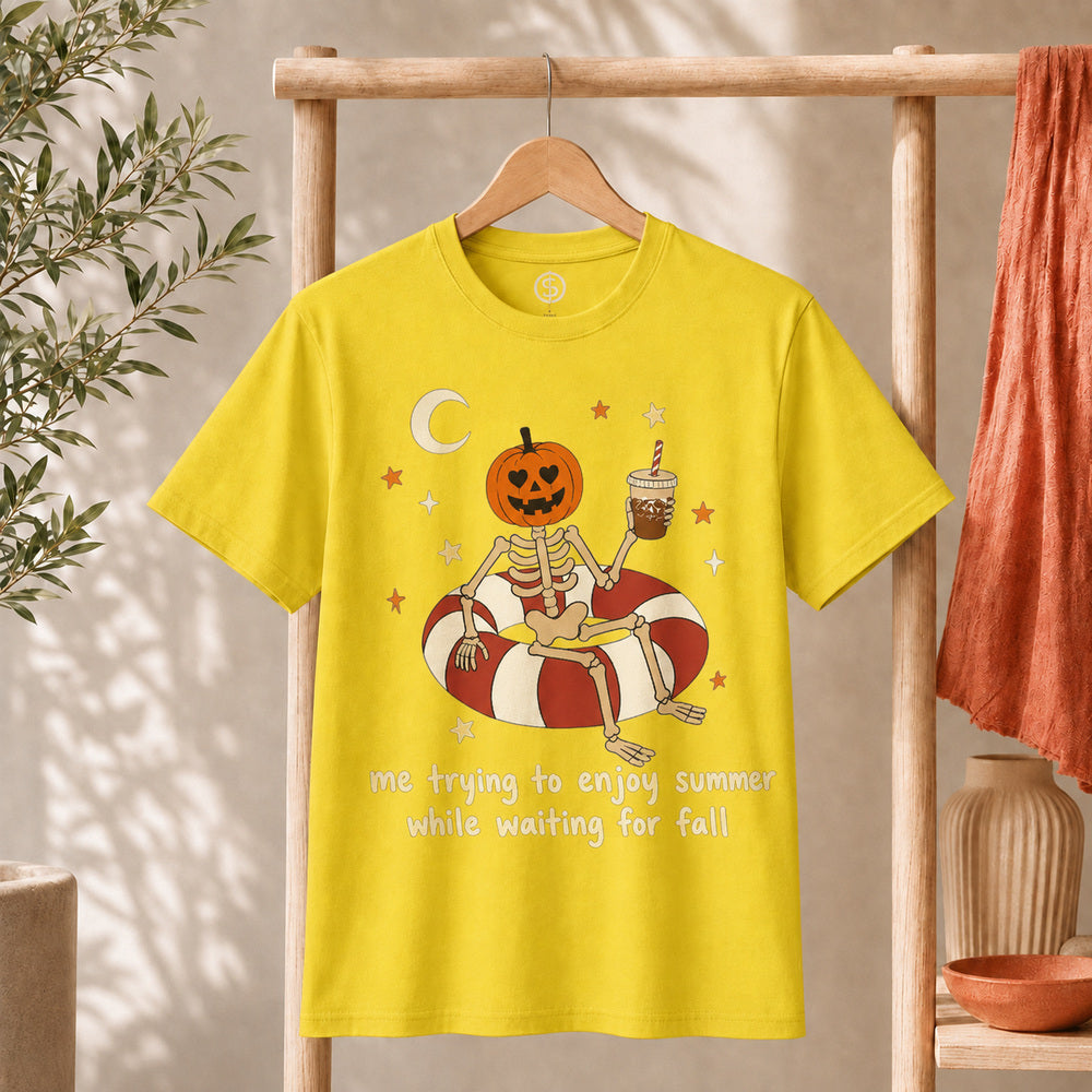 Me Trying to Enjoy Summer While Waiting for Fall Tee featuring a skeleton with a jack-o'-lantern head on a float.