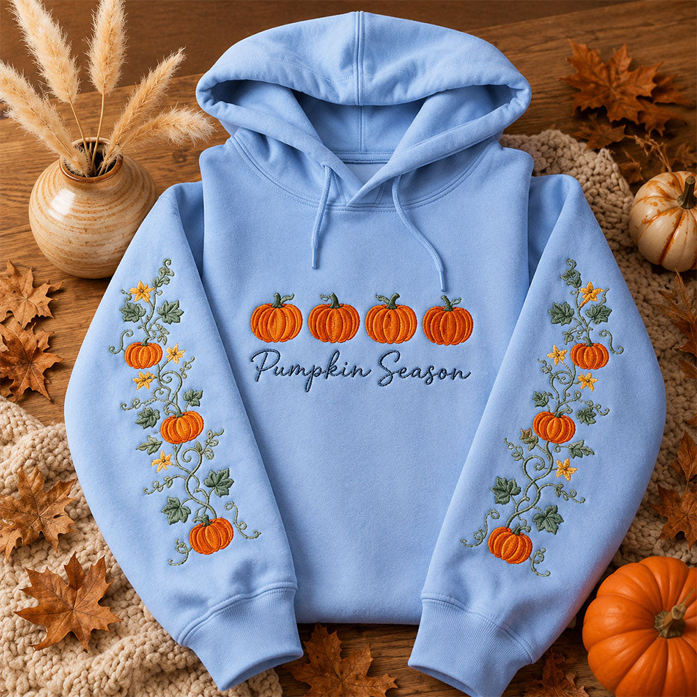 Pumpkin Season Embroidered Hoodie featuring colorful pumpkins and floral design on a light blue background.