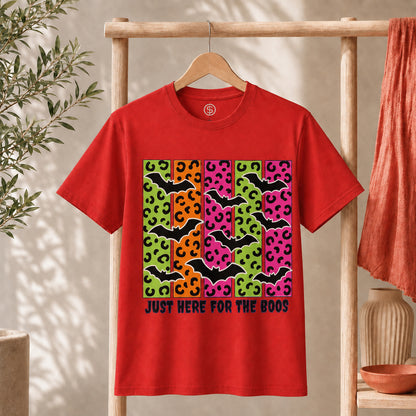 Spooky Bats Graphic Tee featuring colorful bats and the phrase "Just Here for the Boos" on a red shirt.