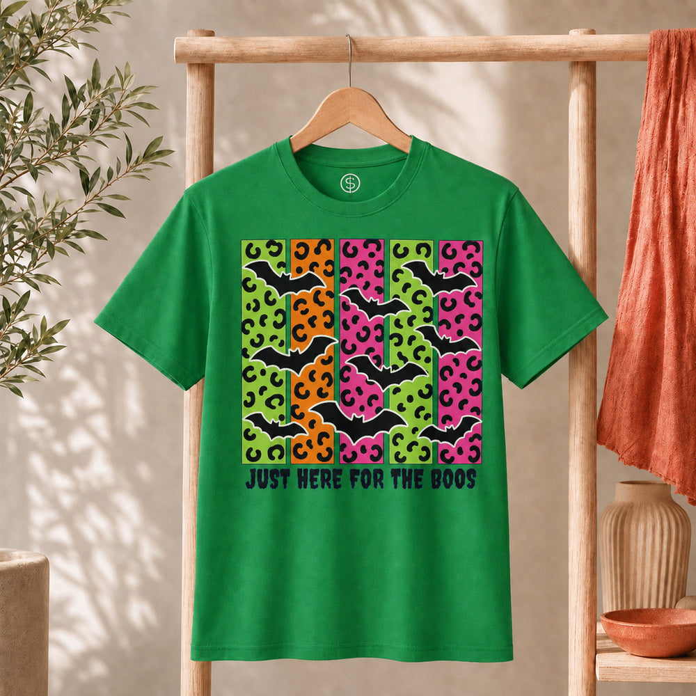 Spooky Bats Graphic Tee features colorful bats and the phrase 'Just Here for the Boos' on a green T-shirt.