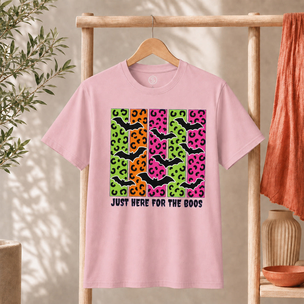 Spooky Bats Graphic Tee featuring colorful bats and the phrase 'Just Here for the Boos' on a pink t-shirt.