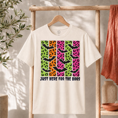 Spooky Bats Graphic Tee featuring colorful bats and the phrase 'Just Here for the Boos' on a light fabric background.